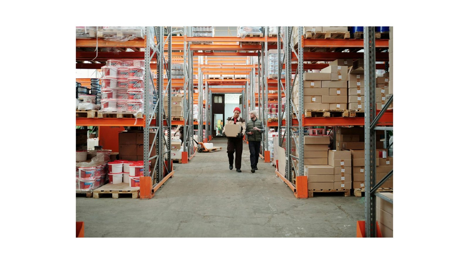 Warehouse aisle stacked with pallets and boxes